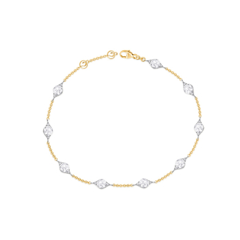 Diamond studded station bracelet in white and yellow gold